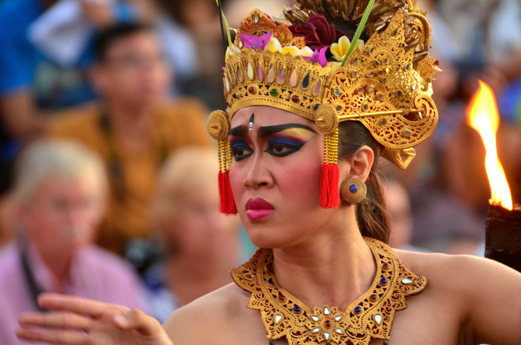 A performer wearing a traditional Balinese headdress and costume performs a traditional Indonesian folk tale drama.